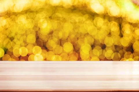 Empty wooden deck table with blurred festive bokeh lights on the background. Stock Photos
