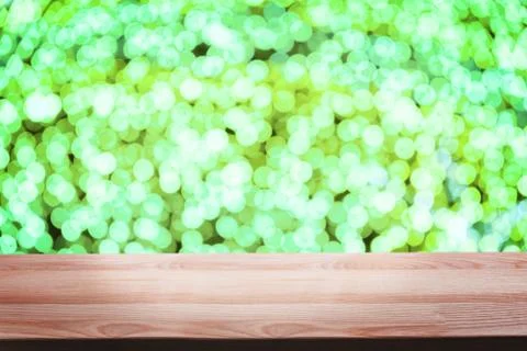 Empty wooden deck table with blurred festive bokeh lights on the background. Stock Photos