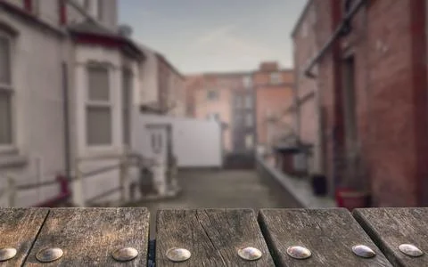 Empty wooden deck table on blurry alley background. Can be used for mockup pr Stock Photos