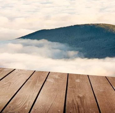Empty wooden deck table with clouds. ready for product montage display. Stock Photos