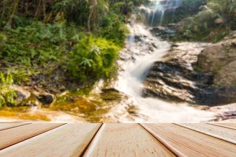 Empty Wooden deck table over blur nature background Stock Photos