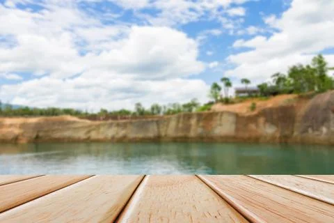 Empty Wooden deck table over blur nature background Stock Photos