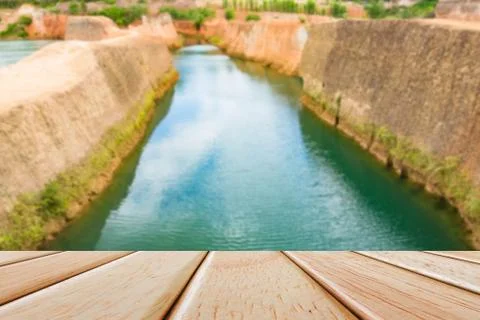 Empty Wooden deck table over blur nature background Stock Photos