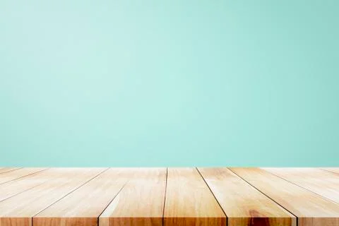 Empty wooden deck table over mint wallpaper background. Stock Photos