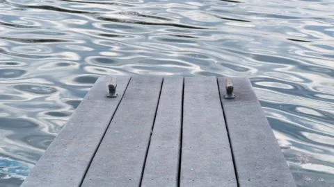 Empty Wooden Dock on Calm Lake - 4K Static Shot - Serene Water Reflection Stock Footage 331663253