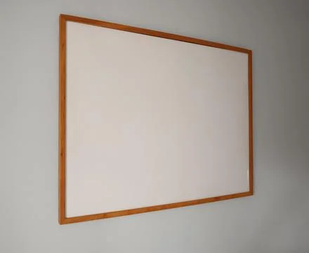 Empty wooden frame hanging on a simple gray wall. Design template for art, .. Stock Photos