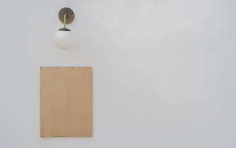 Empty wooden frame with round lamp on empty on clean white cement wall Stock Photos