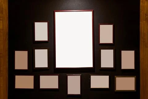Empty wooden frames on dark wall background Stock Photos