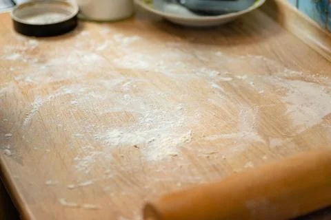 Empty wooden kitchen table dusted with flour photo Stock Photos