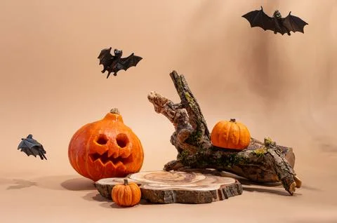 Empty wooden log on table with pumpkin and bats. Halloween or Thanksgiving mo Stock Photos