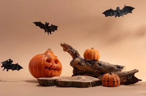 Empty wooden log on table with pumpkin and bats. Halloween or Thanksgiving mo Stock Photos