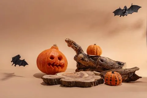 Empty wooden log on table with pumpkin and bats. Halloween or Thanksgiving mo Stock Photos