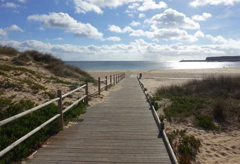 Empty wooden path to beach in winter Stock Photos
