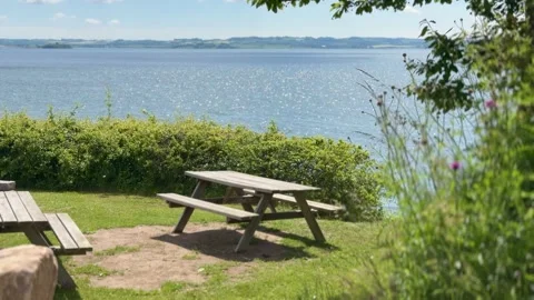 Empty wooden picnic table overlooking the sea Stock-Footage 337303112