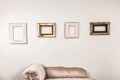 Empty wooden picture frames on a plain white wall for decor Empty wooden p... Stock Photos
