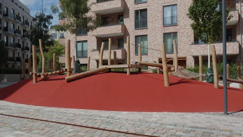 Empty wooden playground with rope hammocks in front of brick flats in Altona Stock Footage 343806805