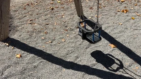 Empty Wooden Playground Swing Moving on Metal Chains Stock Footage 345996680