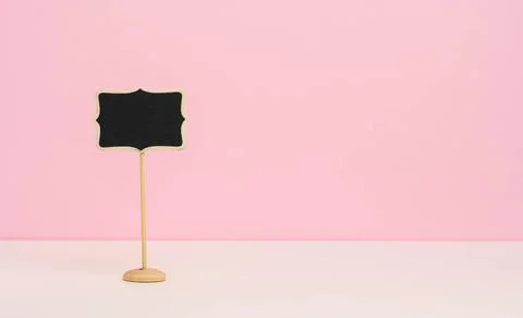 Empty wooden pointer on a stick for writing text, pink background empty wo... Stock Photos