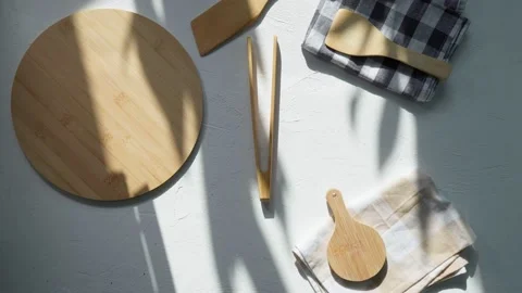 Empty wooden round board on the kitchen table. Wooden pizza plate, a place to Video stock 198805341