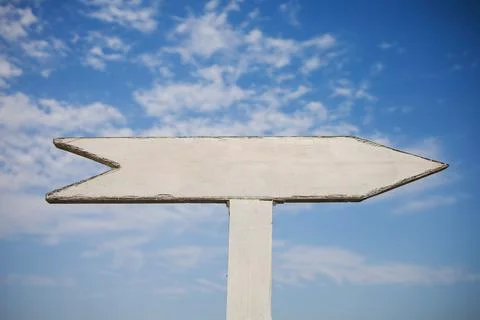Empty wooden sign pointers with a space for text. On blue sky background. Stock Photos