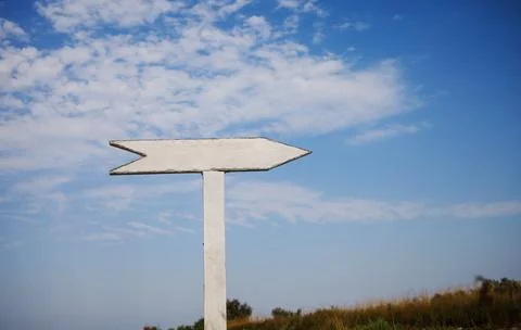 Empty wooden sign pointers with a space for text. On blue sky background. Stock Photos