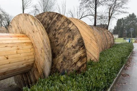 Empty wooden spools for cable winding. Stock Photos