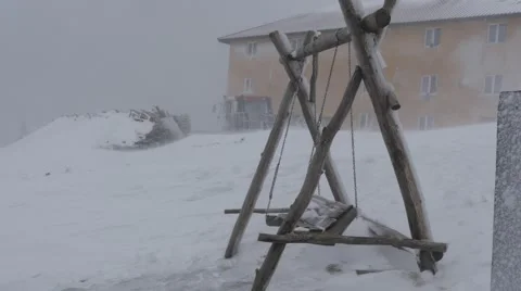 Empty Wooden Swing in Snowstorm Blizzard Stock Footage