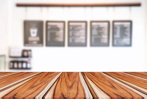 Empty wooden table and blur background of abstract in front of restaurant or Stock Photos