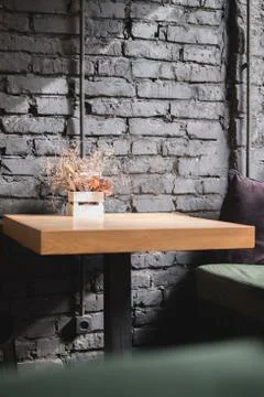 Empty wooden table and window sill with pillow in cafe by the window. Quarantine Stock Photos
