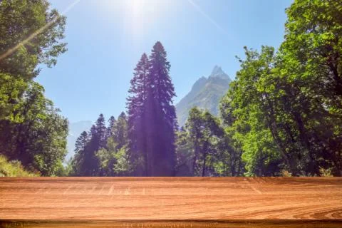 Empty wooden table with blurred background of summer landscape in mountain ar Stock Photos
