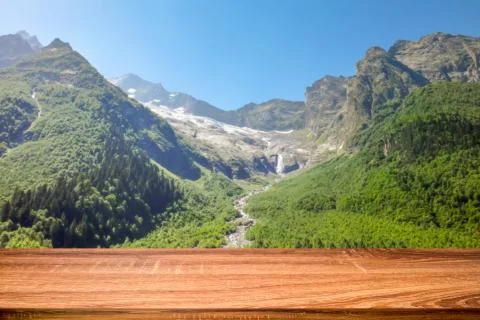 Empty wooden table with blurred background of summer landscape in mountain ar Stock Photos