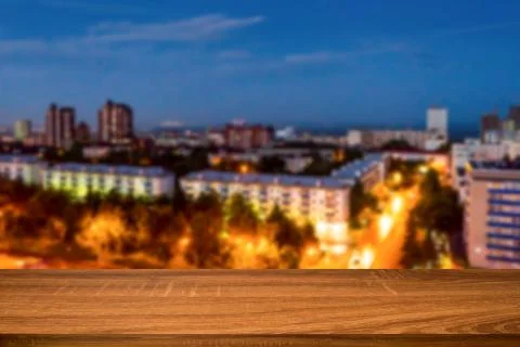 Empty wooden table with blurred background of night city. Can be used for dis Stock Photos
