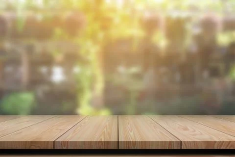 Empty wooden table with blurred background for product display. Stock Photos