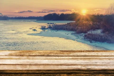 Empty wooden table with blurred picteresque winter background of riverside at Stock Photos