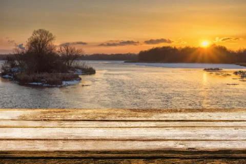 Empty wooden table with blurred picteresque winter background of riverside at Stock Photos