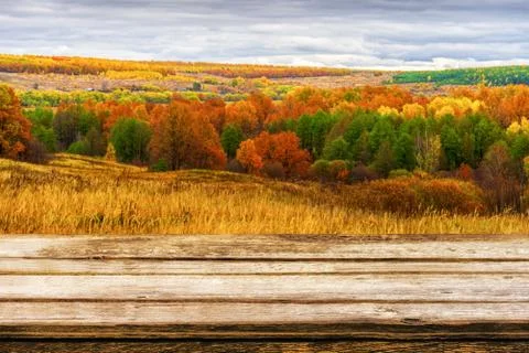 Empty wooden table with blurred picturesque autumn landscape of panoramic vie Stock Photos