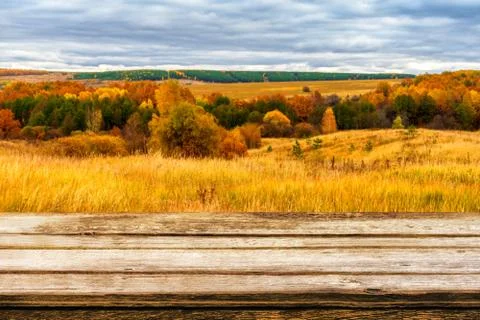 Empty wooden table with blurred picturesque autumn landscape of panoramic vie Stock Photos