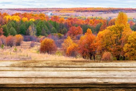 Empty wooden table with blurred picturesque autumn landscape of panoramic vie Stock Photos