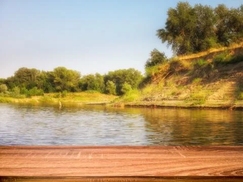 Empty wooden table with blurred summer background of riverside in the daytime Stock Photos