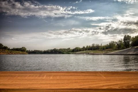 Empty wooden table with blurred summer background of riverside in the daytime Stock Photos