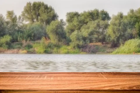 Empty wooden table with blurred summer background of riverside in the daytime Stock Photos