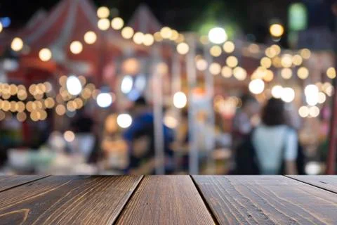 Empty wooden table of brown on front blurred colorful background, for present Stock Photos