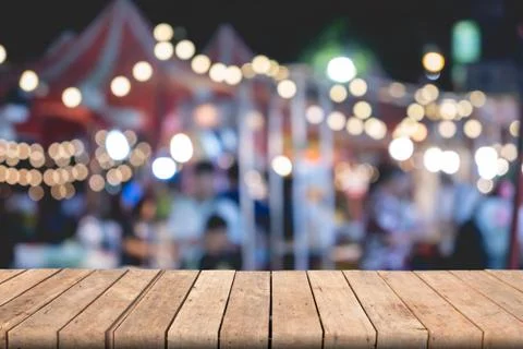Empty wooden table of brown on front blurred colorful background, for present Stock Photos