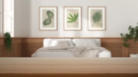Empty wooden table, desk or shelf with blurred view of modern white bedroom,  Illustrazione stock