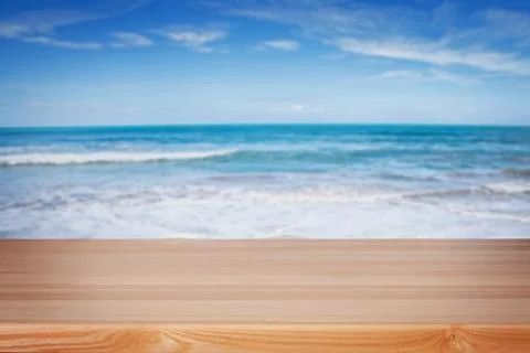 Empty wooden table for display on the background of blurred beach Stock Photos