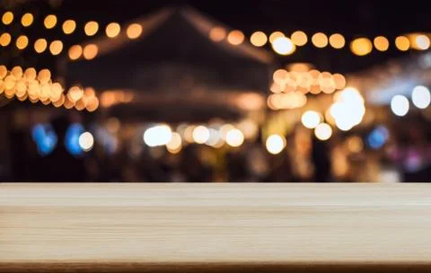 Empty wooden table in front of abstract blurred festive background with light Stock Photos