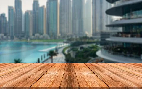 Empty wooden table in front of abstract blurred background of Coastal city Stock Photos