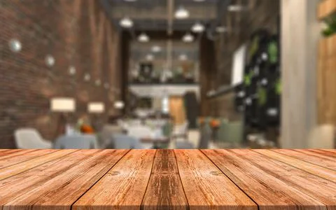 Empty wooden table in front of abstract blurred background of coffee shop Stock Photos