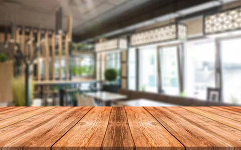 Empty wooden table in front of abstract blurred background of shopping mall Stock Photos