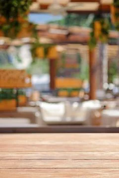 Empty wooden table in front of blur Abstract and defocused coffee shop cafe a Stock Photos